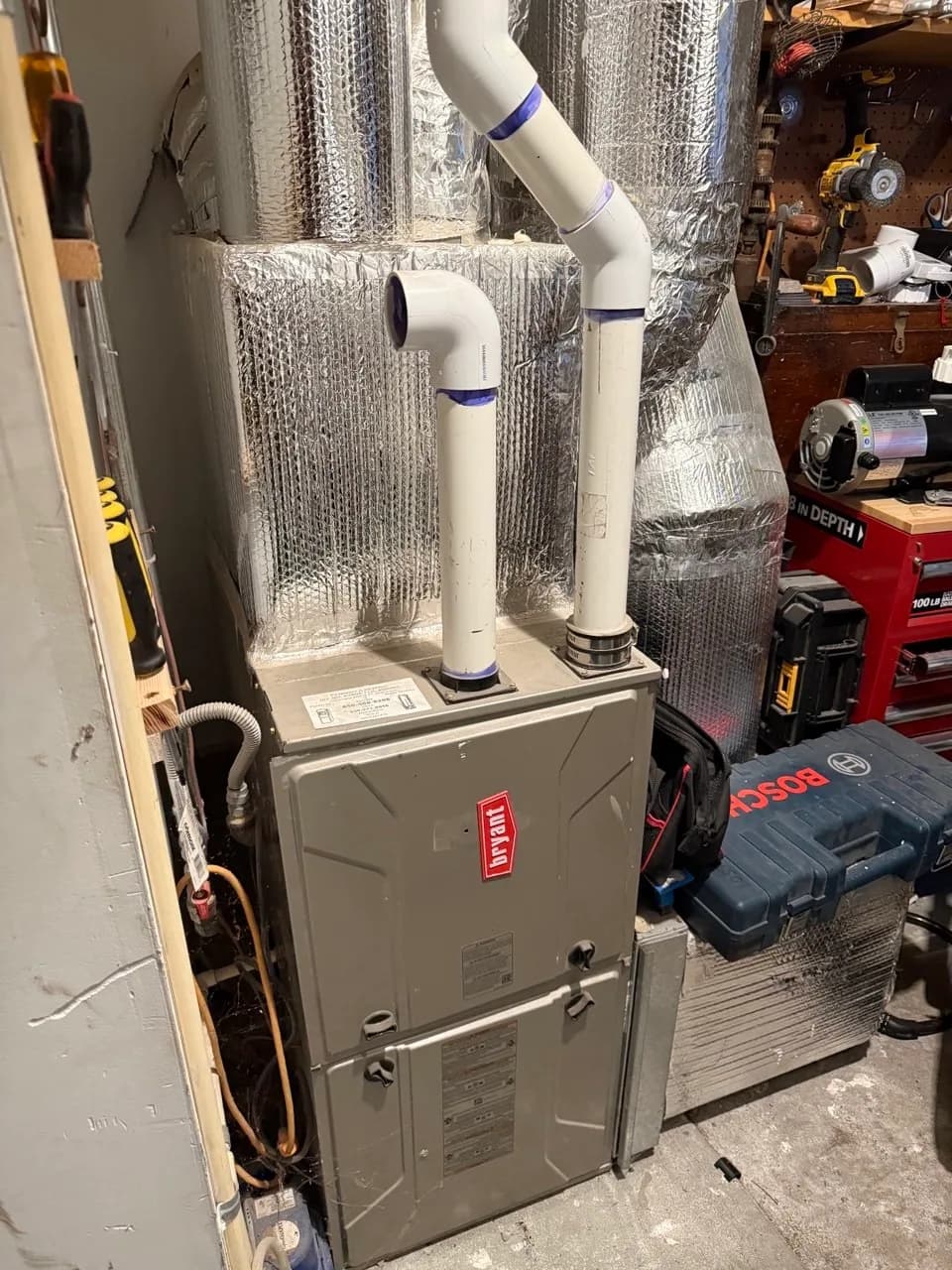 Gas furnace connected to insulated ductwork in a basement